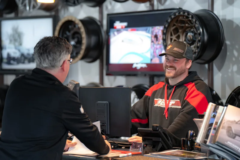 A conversation at the counter inside Automotive Concepts