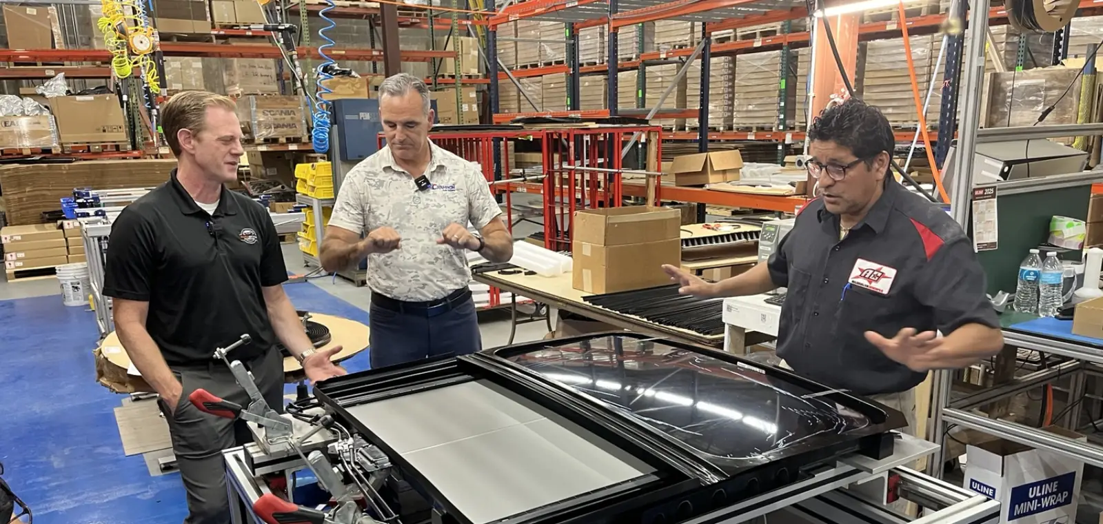 Jesse Stoddard and Bill Champion discussing automotive sunroof manufacturing at Champion Auto Systems