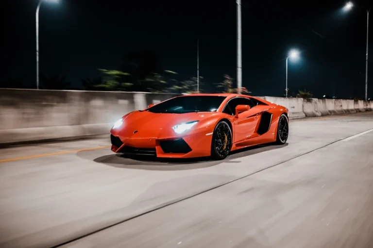 Red sports car on a road at night